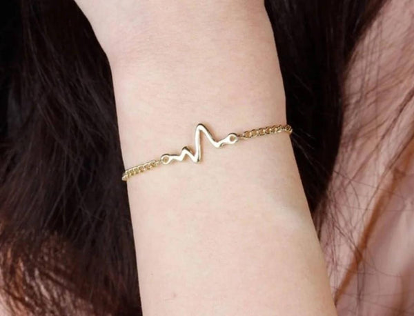 gold Heart bat bracelet , on wrist
