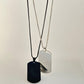 silver-black dog tag pendant , white background , front side