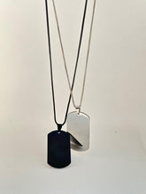 Black-silver dog tag pendant . white background , Front view