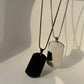 silver-black dog tag pendant . ride side